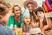 A multi-generational family celebrating a child's birthday