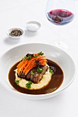 Braised collar of lamb with ginger carrots, mashed potatoes and a sweet and sour sauce