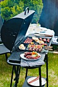 Sausages, skewers and vegetables on a charcoal barbecue