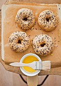 Bagels with black caraway seeds on a piece of baking paper