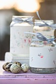 Screw-top jars decorated with floral pattern and quails' eggs