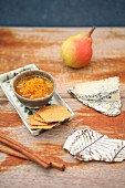 Pear and saffron sauce with cheese and crackers