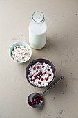 Puffed wholemeal buckwheat with milk and pomegranate seeds and a bottle of milk