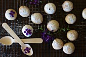 Shortbread cinnamon cookies on a cooling rack with violets