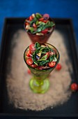 Tomato and aubergine salad with spinach and sweet onions in glasses