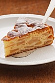 A slice of French apple cake on a cake slice