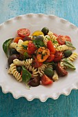 Pasta salad with fresh tomatoes, olives and basil