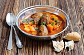 Braised pork cheeks with tomatoes and pumpkin