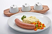 Smoked sausage with mashed potatoes and colourful vegetables