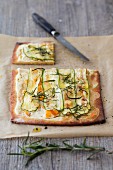 Tarte flambée with goat's cream cheese, courgettes, apricots and rosemary