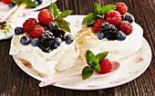 Mini pavlovas filled with cream and berries (Australia)