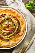 A rose tart with courgette, carrots and bacon