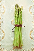 A bundle of green asparagus on a tablecloth
