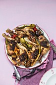 Crispy roast chicken legs with spring onions and peppers