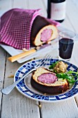 Sausage wrapped in brioche with mustard and red wine