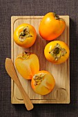 Persimmons, whole and halved
