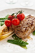 Lamb steak with chicory and cherry tomatoes