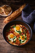 Fried eggs with tomatoes, peppers and onions