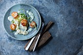 Fried scallops with purée and a herb sauce