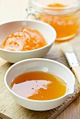 Apricot jam and honey in porcelain bowls