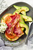 Pancakes with bacon, tomatoes and avocado