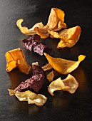 Vegetable chips on a black surface