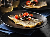 Fried seabass with tomatoes and olives