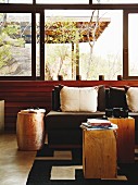 Solid wooden side tables and scatter cushions on sofa in lounge area