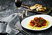 Osso bucco on a bed of risotto with garlic bread (Italy)