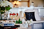 White wine with raspberries in crystal glasses in elegant interior