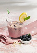 A blueberry and banana smoothie made with almond milk, yoghurt and oats