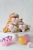 Doughnuts with pink meringues, paper streamers, balloons, and a tiara