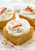 Carrot cake decorated with cream cheese frosting and sugar carrot