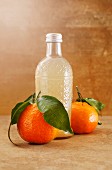 Homemade mandarin lemonade in a glass bottle