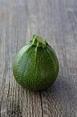 A round, green Eight Ball courgette