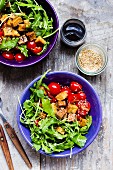 Rocket salad with sesame seed tofu and cherry tomatoes