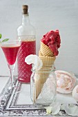 An ice cream cone with raspberry ice cream and home-made raspberry liqueur