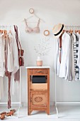 Clothes in natural shades on open clothes rails