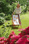 Woman with revamped deckchair in garden