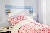 DIY bed headboard made from MDF panels covered in blue and white polka-dot fabric