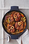 Osso buco with vegetables in a braising dish