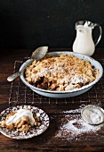 Homemade apple pie with cream and icing sugar