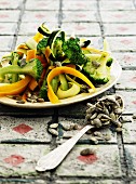 Vegetable salad with broccoli, pumpkin seeds and courgette and carrot strips
