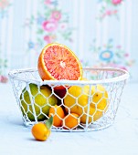Various citrus fruit in a wire basket