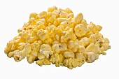 A pile of buttered popcorn on the white surface