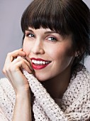 Dark-haired woman wearing white knitted sweater