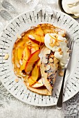 Peach pancakes with orange zest and flaked almonds