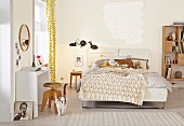 Bedspread with smocked diamond pattern on double bed in bedroom painted pale yellow; white console table against wall