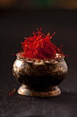 Saffron threads in a metal bowl