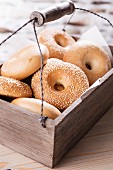 Bagels in a wooden crate with a carrying handle
